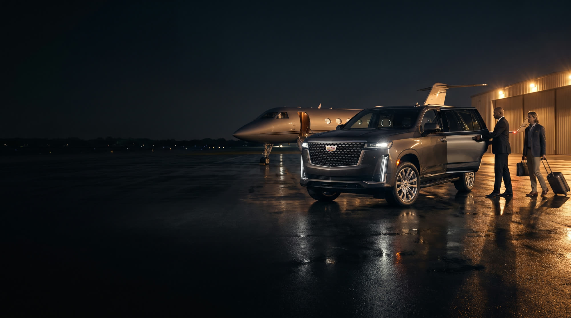 Black Escalade and chauffeur beside a private jet on a night tarmac